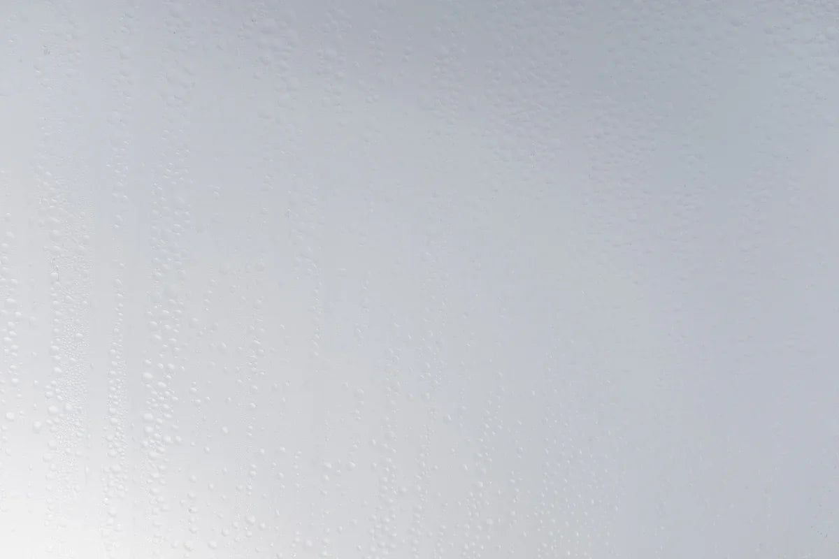a white wall with water drops on it