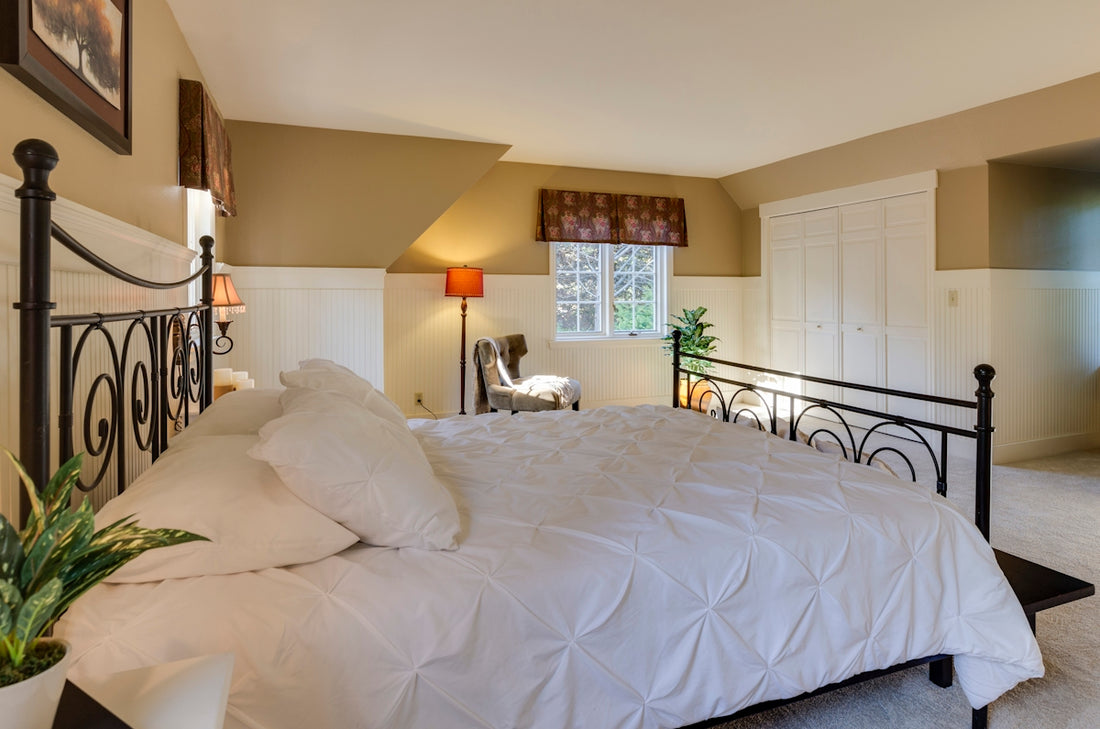 white mattress sheet and four white pillows