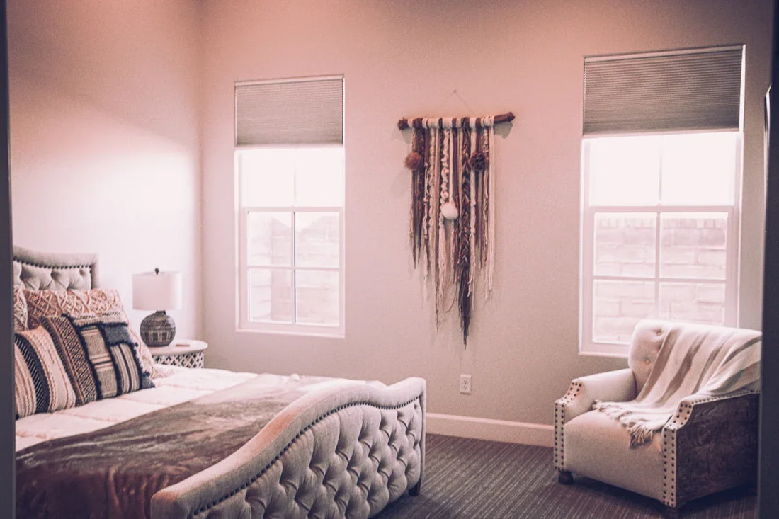 white bed near window with brown curtain