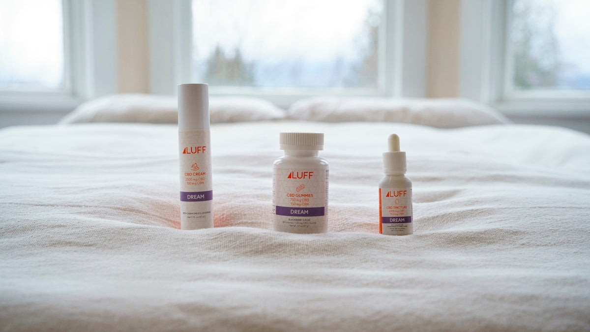 three white plastic bottles on white textile