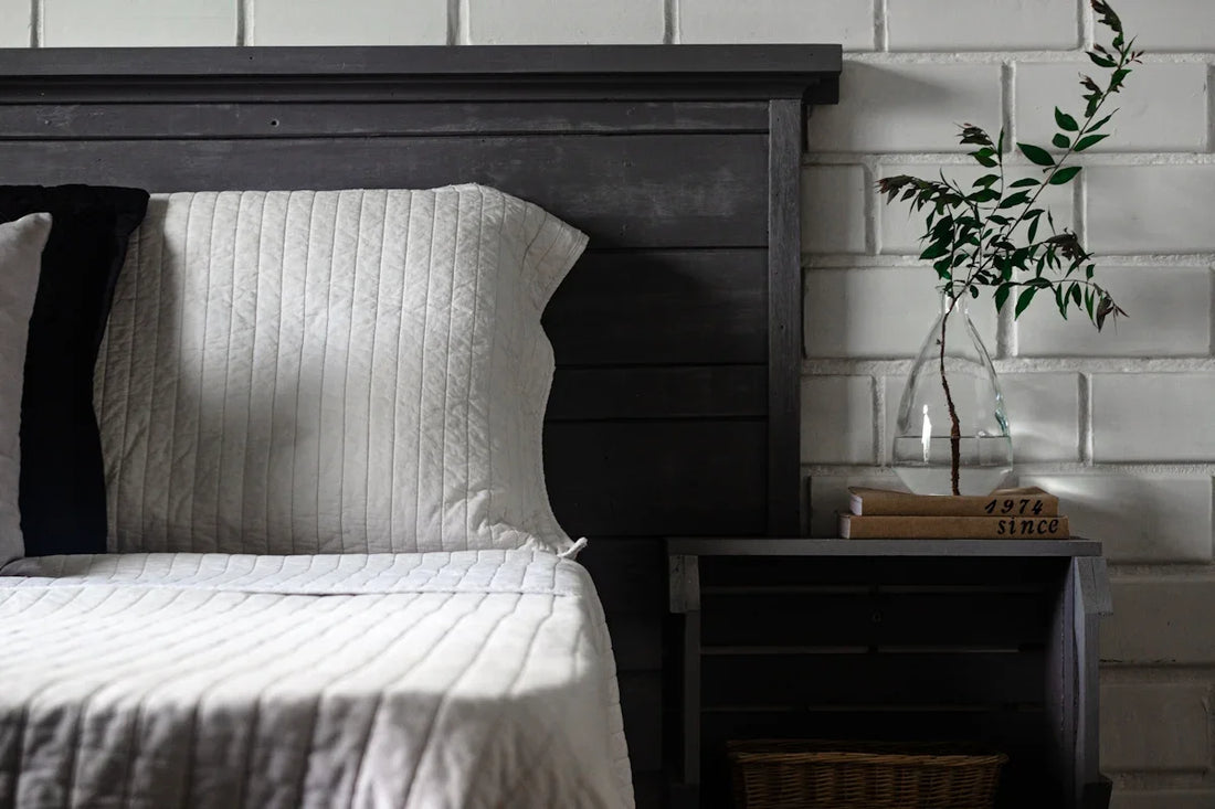 a bed with a vase of flowers