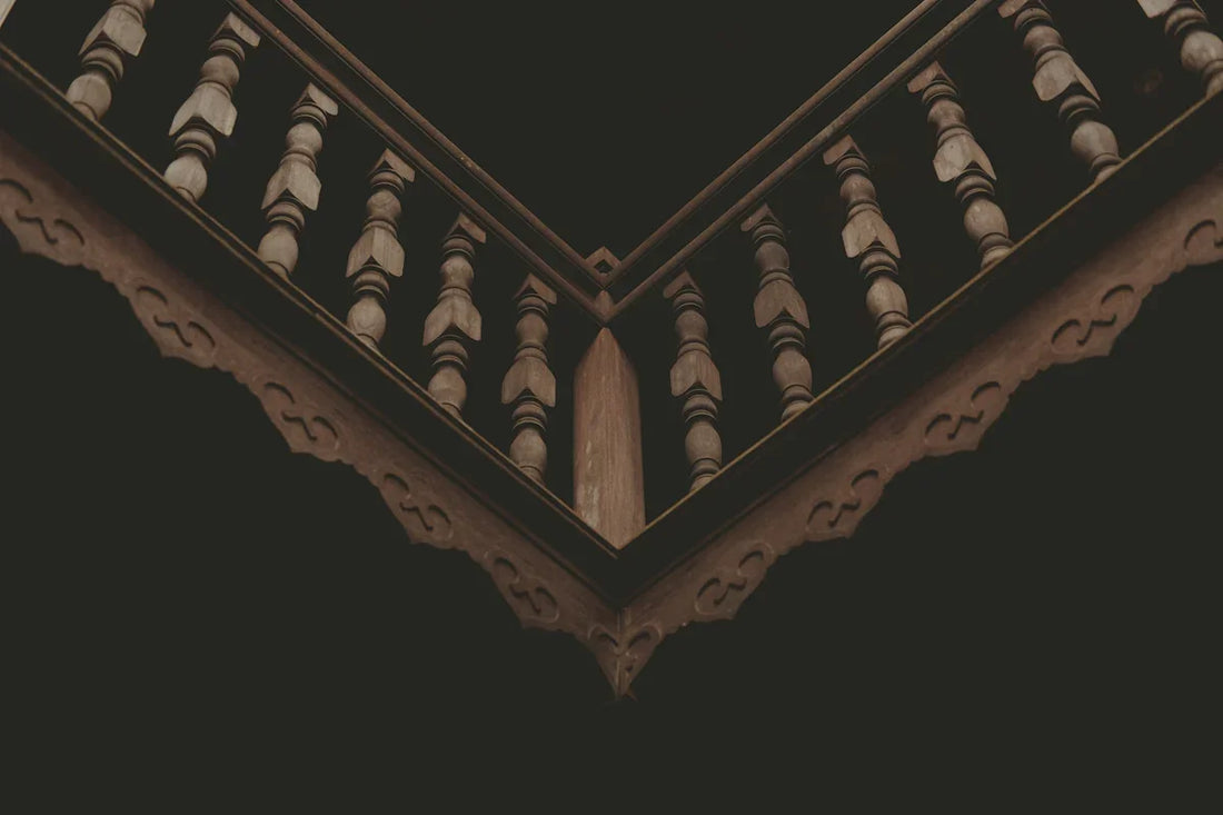 a close up of a balcony railing with a black background