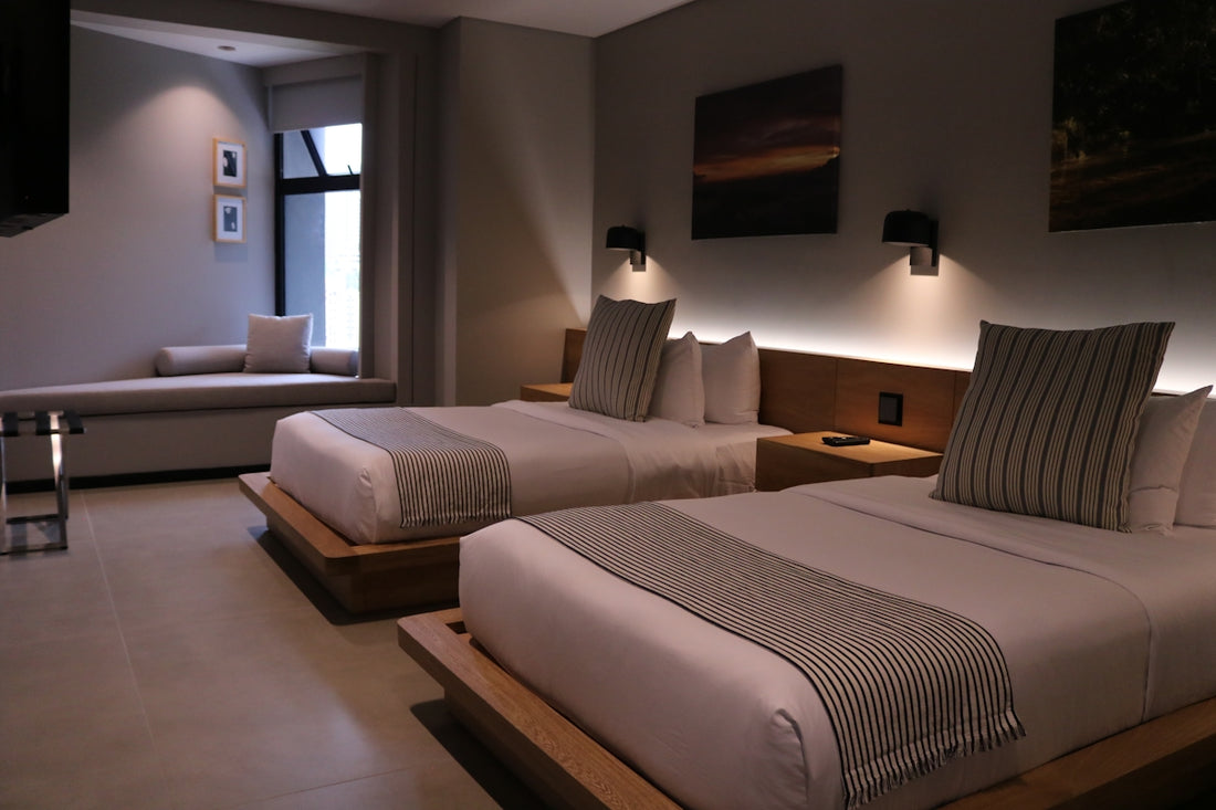 a hotel room with two beds and a couch