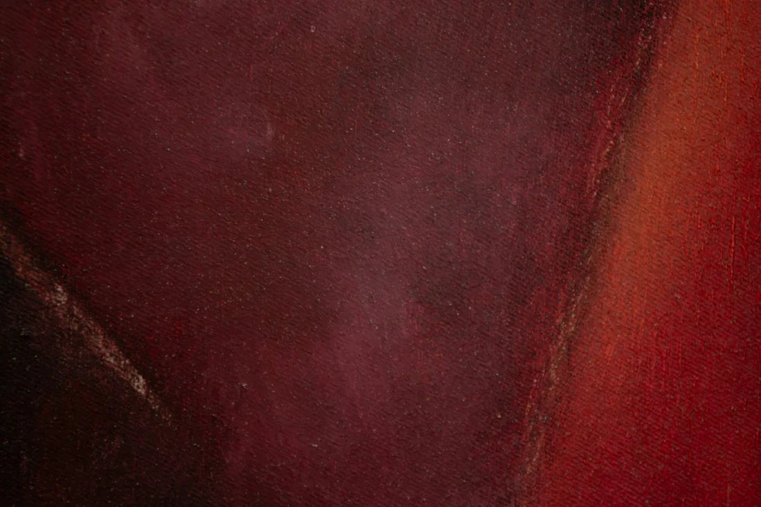 a close up of a red and black painting