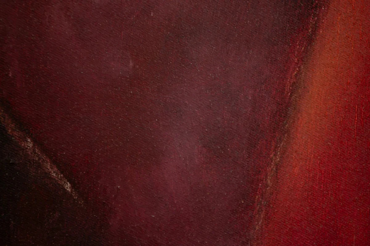 a close up of a red and black painting