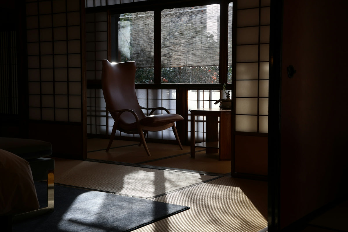 A room with a chair and a window in it