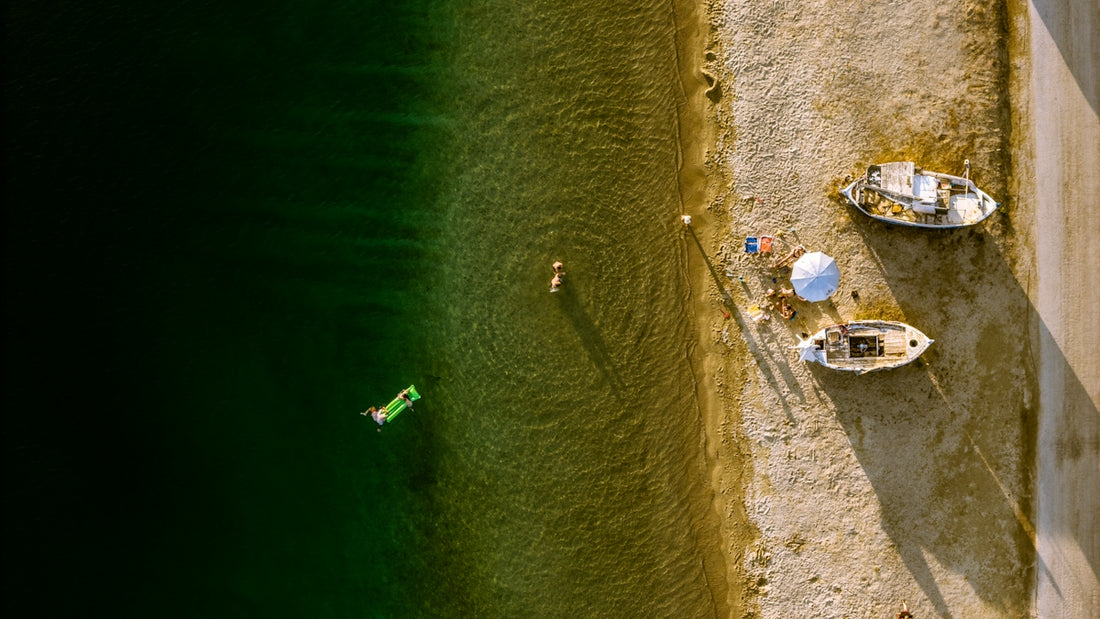 Aerial view of people and boats on a sunny beach