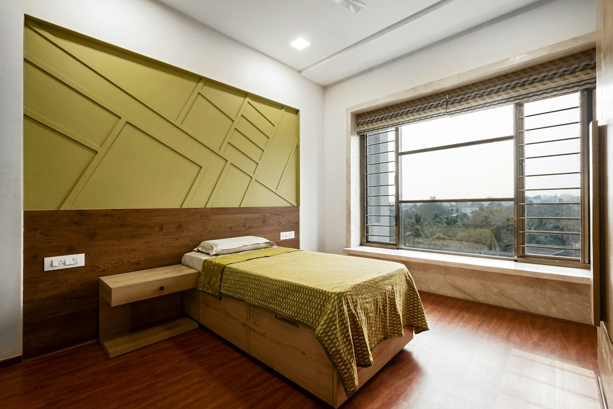 A modern bedroom with a large window and bed