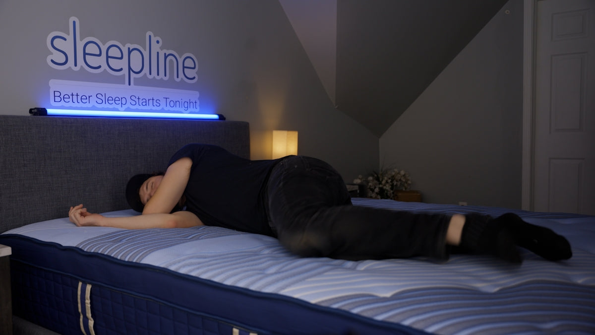Person sleeping on their side on a mattress.