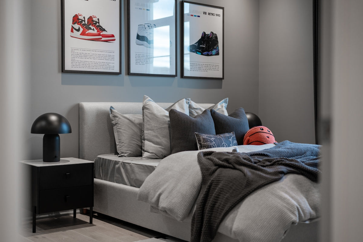 Bedroom with framed sneakers and a basketball.