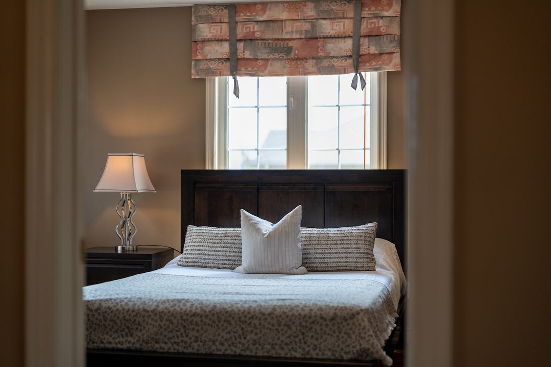 A cozy bedroom with a queen-size bed and window.