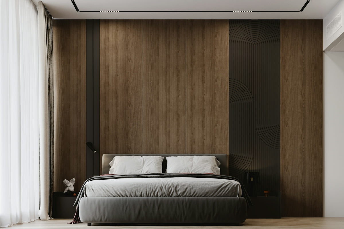 A modern bedroom with a grey bed against a wood paneled wall